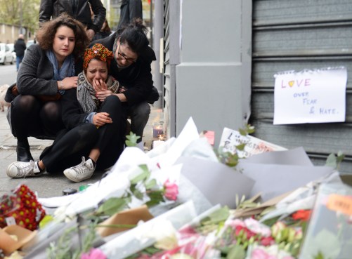 A woman cries near Le Petit Cambodge restaurant, the day after a deadly attack on November 14, 2015 in Paris, France. 