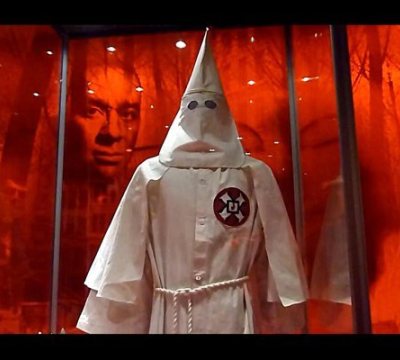 This February 25, 2011 video image shows the image of an African American man behind a Ku Klux Klan (KKK) robe on exibit as part of the 'American I AM: The African Imprint' at the National Geographic in Washington, DC.